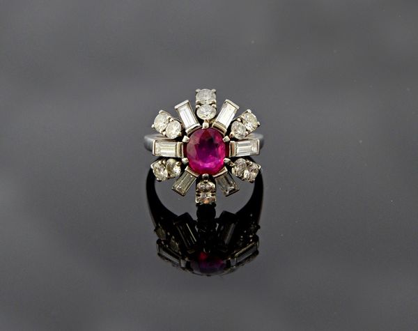 A ruby and diamond set cluster ring, claw set with the oval cut ruby at the centre, in a diamond set surround, mounted with six pairs of circular cut