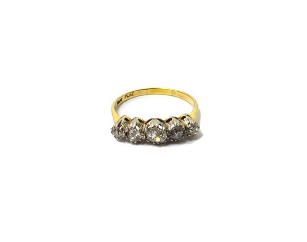 A gold and platinum, diamond set five stone ring, mounted with a row of cushion shaped diamonds, graduating in size to the centre stone, detailed 18 C