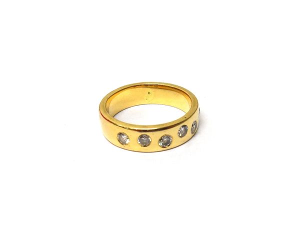 A gold and diamond set six stone band ring, gypsy set with circular cut diamonds, ring size S and a half, gross weight 10.5 gms.