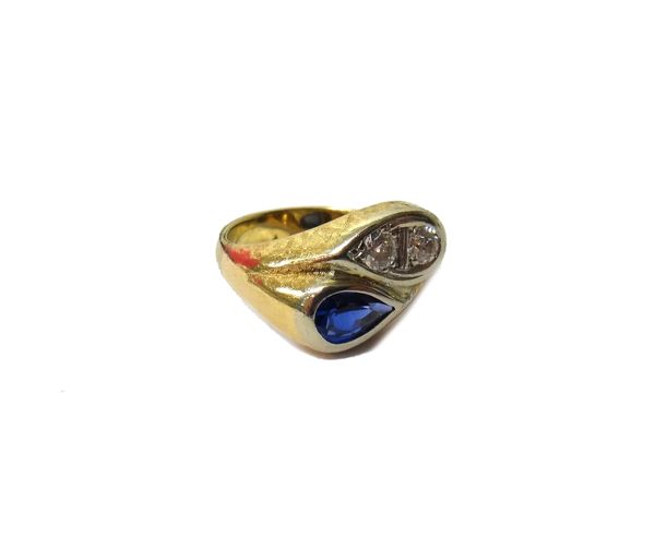 A gold, synthetic sapphire and diamond set ring, mounted with a pear shaped synthetic sapphire and with two cushion shaped diamonds in a twist over de