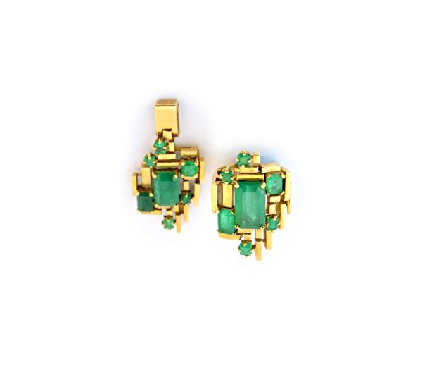 A gold and emerald set ring, in an angular geometric abstract design, claw set with seven rectangular and square cut emeralds and with the principal e