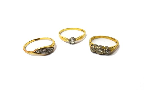 A gold ring, claw set with a cushion shaped diamond, a gold and diamond set five stone ring, mounted with cushion shaped diamonds in a scrolling desig