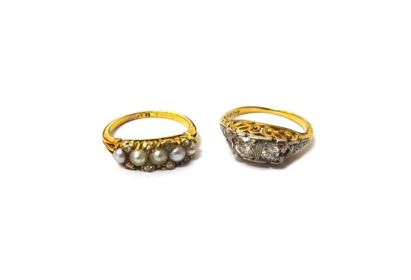 A gold ring, mounted with two cushion shaped diamonds, otherwise with pierced and engraved decoration, ring size I and a gold ring, mounted with a row