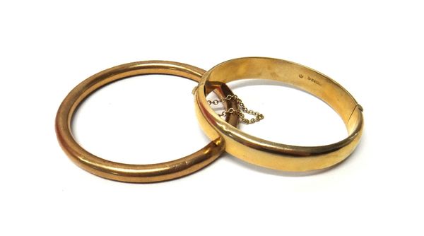 A 9ct gold oval hinged bangle, the front with scroll engraved decoration, on a snap clasp, fitted with a safety chain, Chester 1959 and a 9ct gold cir