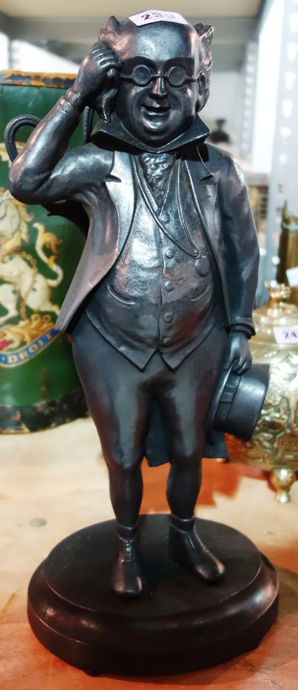 A cast iron fire tool stand in the form of a man.