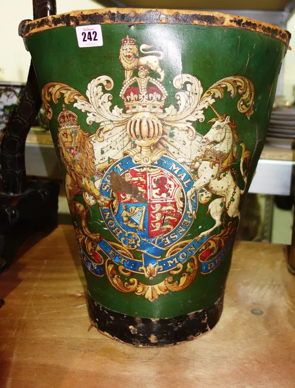 A green leather bucket with a Royal Coat of Arms decoration.