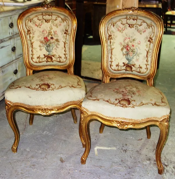 A pair of Louis XV style gilt framed side chairs, with serpentine seats on cabriole supports. (2)