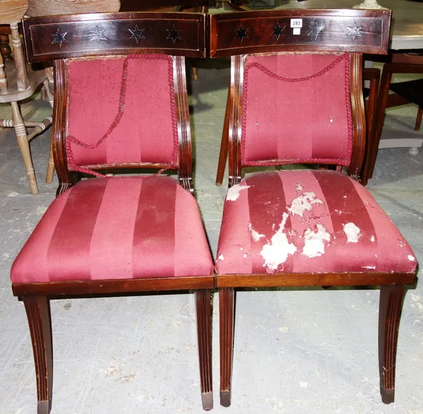 A pair of early 19th century French mahogany framed dining chairs on sabre front supports. (2)