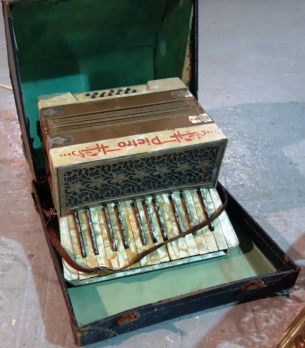 An early 20th century cased accordion.