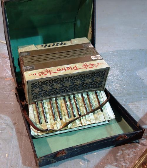 An early 20th century cased accordion.