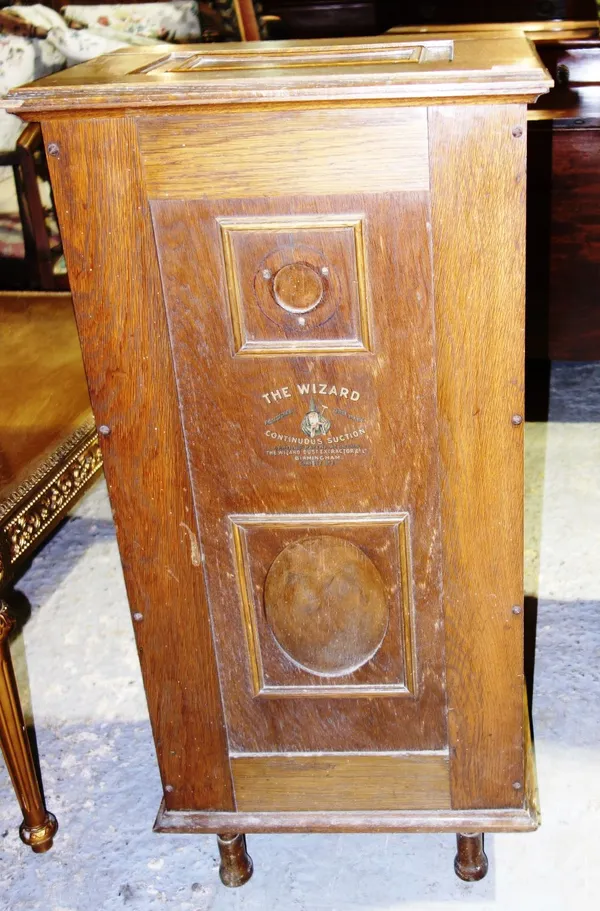 A 20th century oak side cupboard, formerly from a Wizard vacuum cleaner.