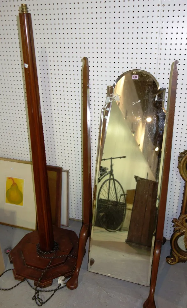 A 20th century mahogany cheval mirror and a walnut standard lamp. (2)