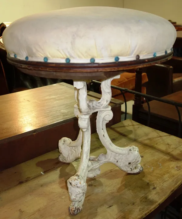 A white painted cast iron stool with swivel seat.