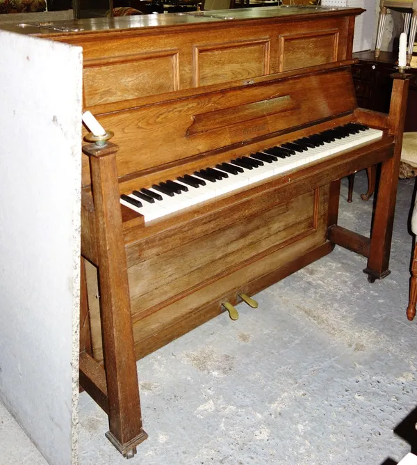 An oak Arts and Crafts style upright piano.