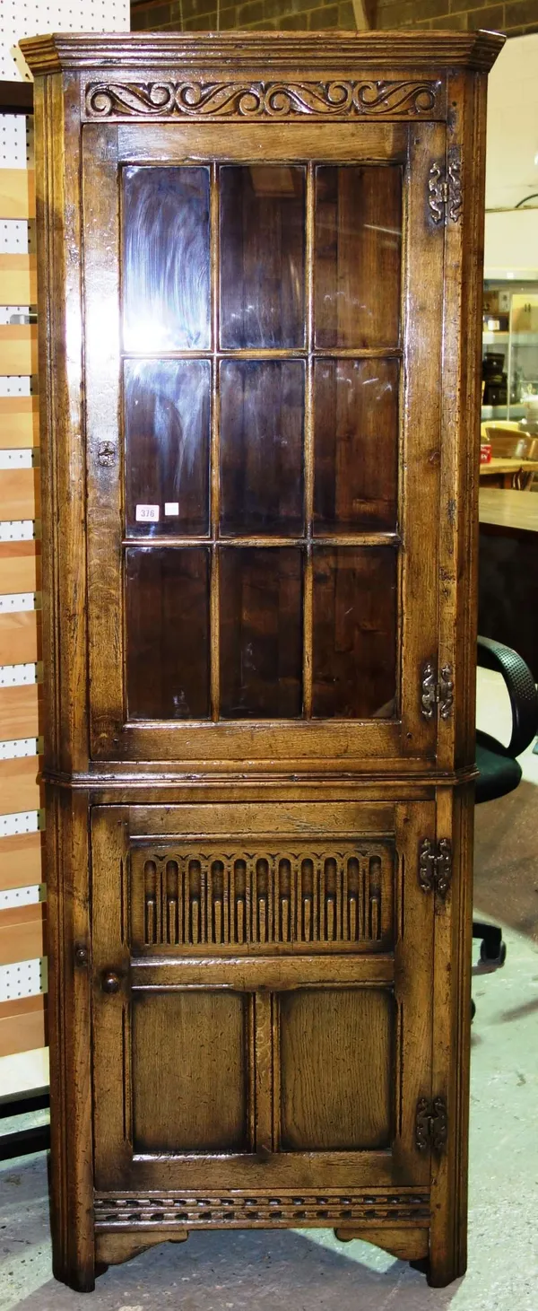 A 20th century oak corner cupboard with glazed top section.
