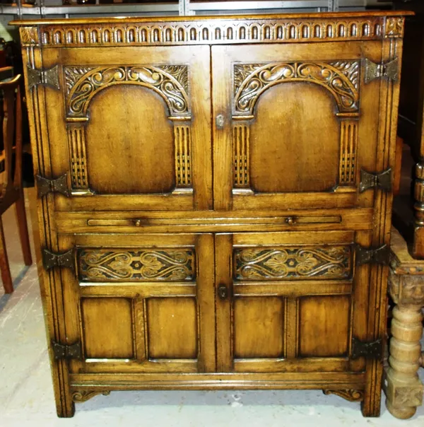A 20th century oak side cabinet, with two pairs of cupboards.