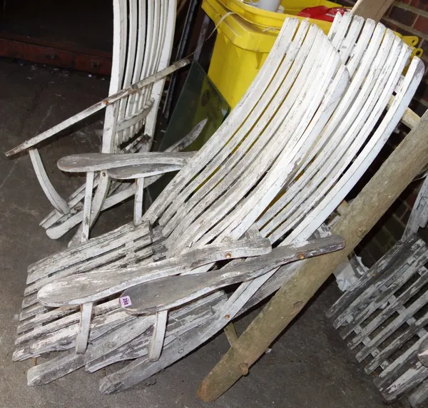 A set of four white painted folding chairs. (4)