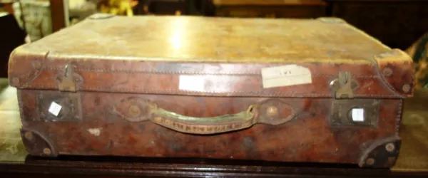 An early 20th century brown leather suitcase.