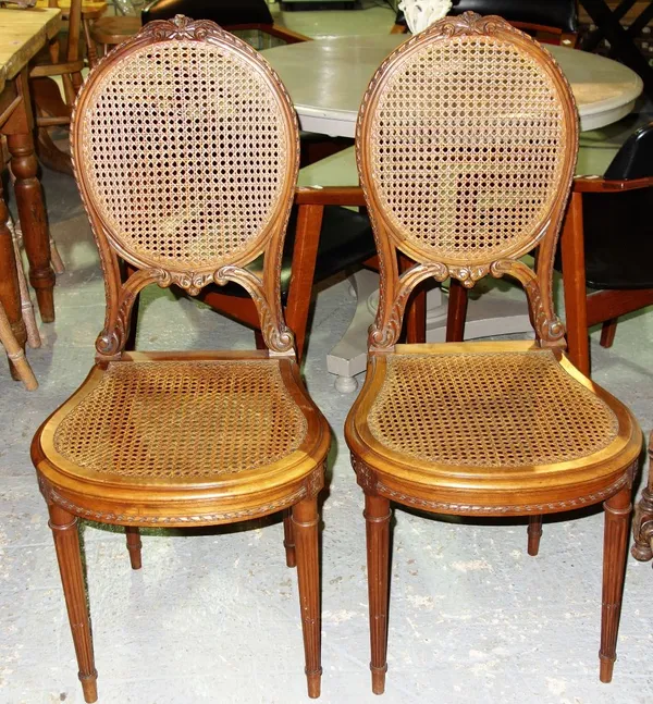 A pair of Louis XV style beech and cane bedroom chairs. (2)