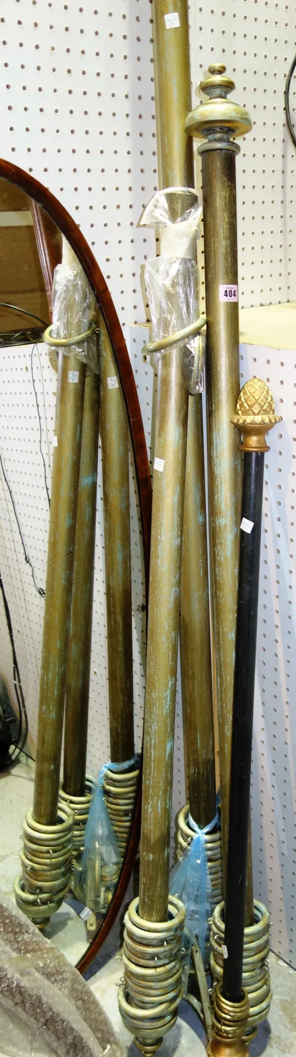 A group of three 20th century gilt curtain poles. (3)