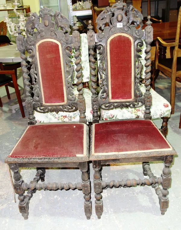 A pair of Victorian carved oak chairs. (2)