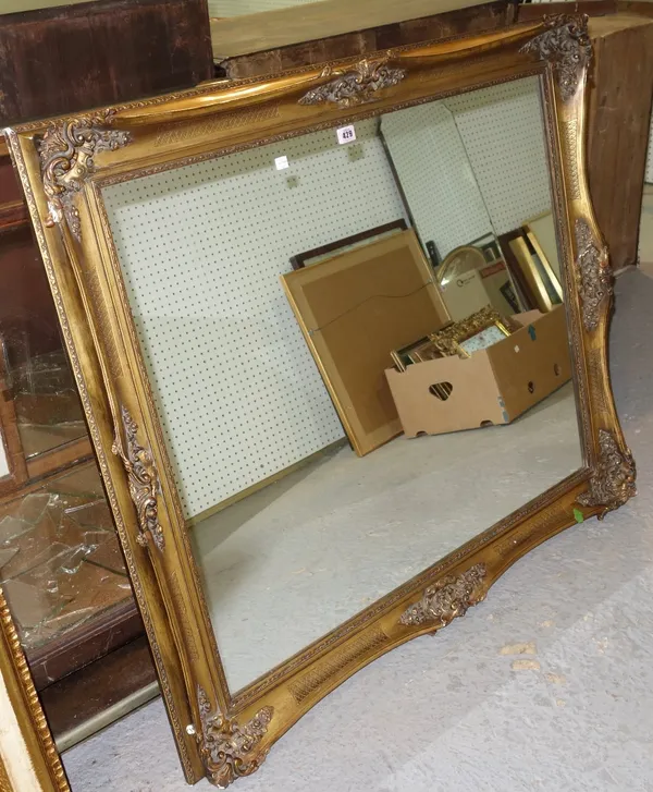 A large gilt framed wall mirror.