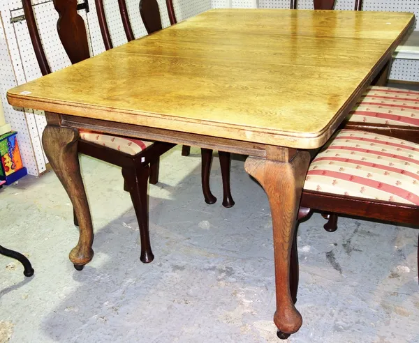 An oak rectangular extending dining table.