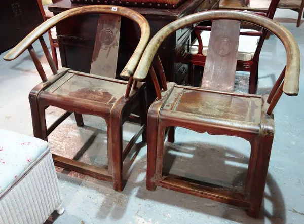 A pair of early 20th century Chinese hardwood horseshoe back chairs. (2)