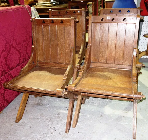 A set of four oak Gothic revival Glastonbury style chairs. (4)