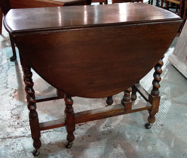 A 20th century oak drop flap dining table.