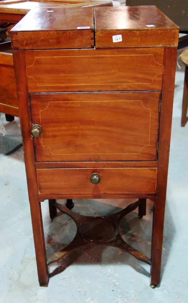 A mahogany double lift top washstand cabinet.