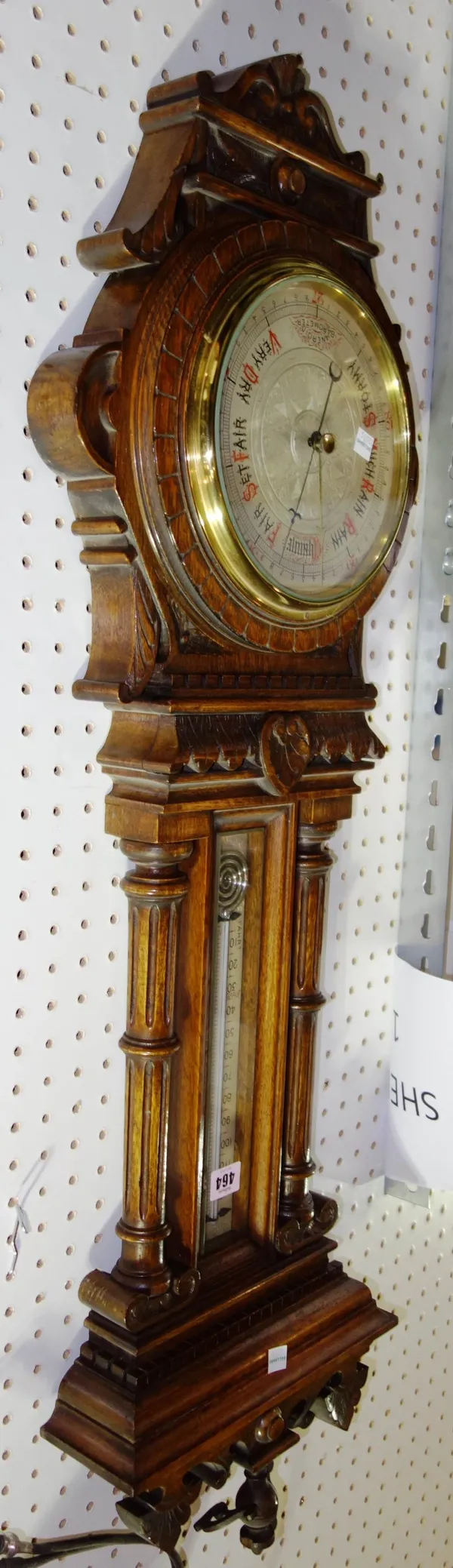 An oak cased aneroid wall barometer.