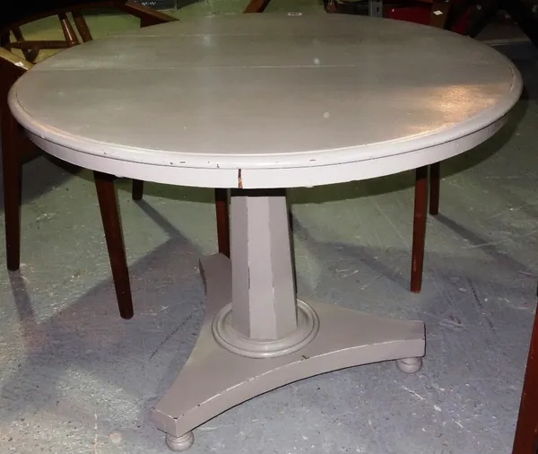A 19th century grey painted circular tilt top table.