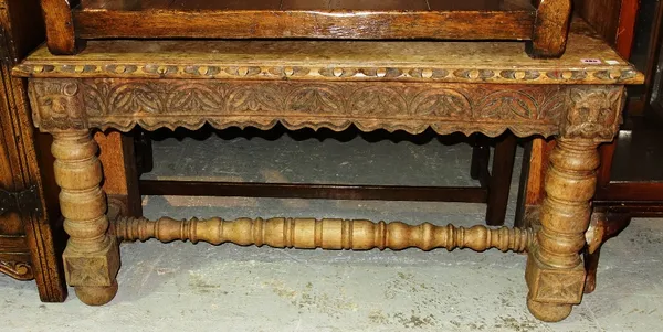 An oak rectangular bench with carved decoration.