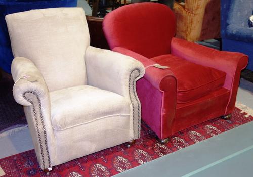 A red upholstered 20th century armchair and a cream armchair. (2)