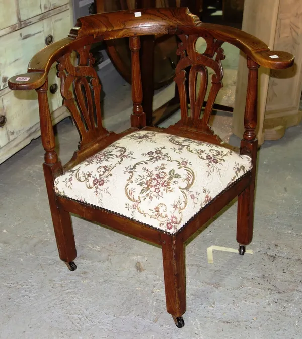 An 18th century and later oak elbow chair.