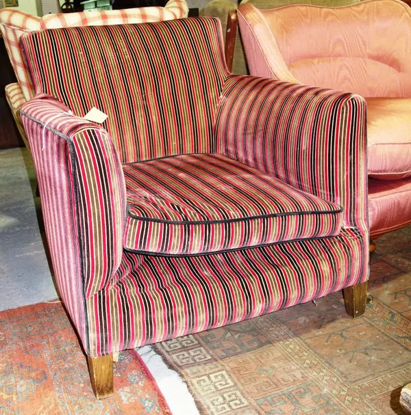 A striped velvet upholstered armchair.