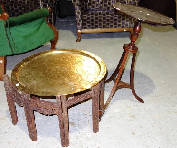 A 19th century mahogany and inlaid tripod table, and a folding brass and wood Eastern table. (2)