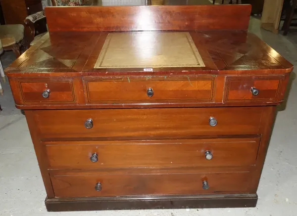 A walnut desk with associated three drawer base.
