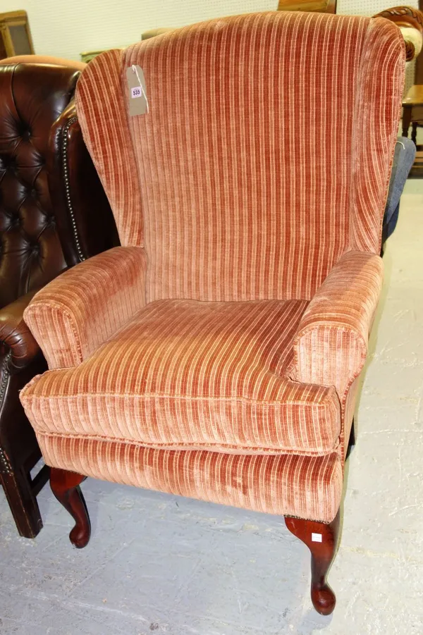 A 20th century orange upholstered armchair.