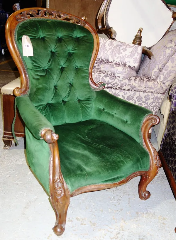 A Victorian green button upholstered armchair.