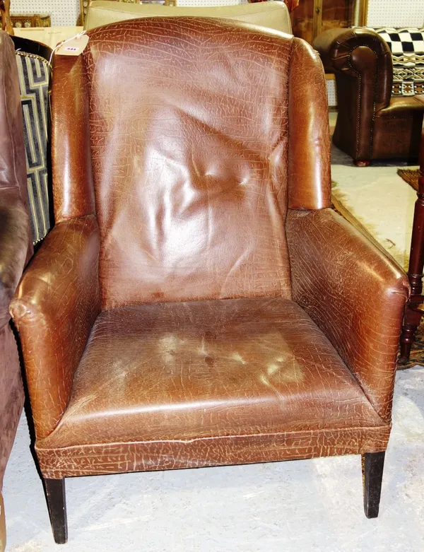 A 20th century brown leather low armchair.