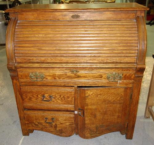 An early 20th century oak roll top desk.