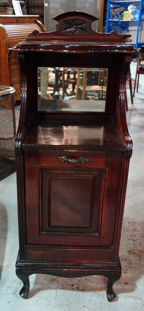A mahogany coal purdonium with mirrored back.