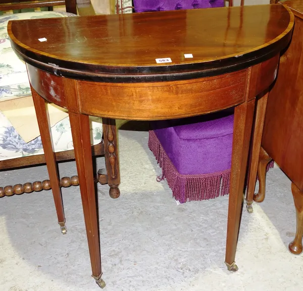 A mahogany demi lune fold over table.