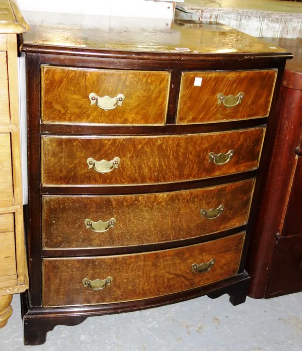 A 20th century walnut chest of two short and three long drawers.