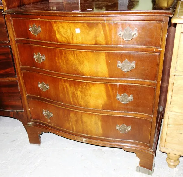 A 20th century serpentine mahogany chest of drawers.