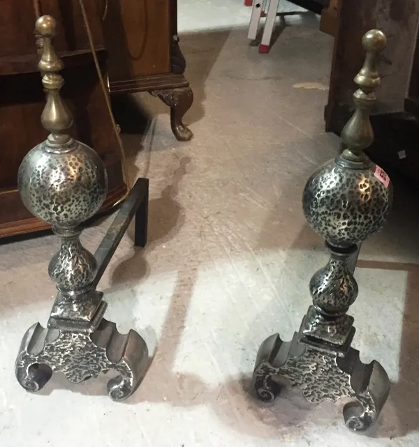 A pair of steel and brass fire dogs.