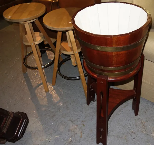 A 20th century mahogany coopered jardiniere and a pair of height adjustable pine stools.  (3)