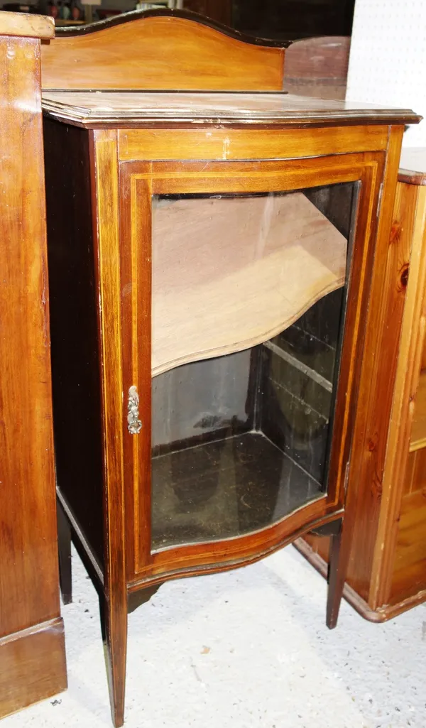 A 19th century mahogany glazed serpentine display cabinet.